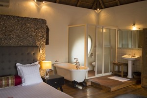 Room and bath at Le Petit Village Hotel